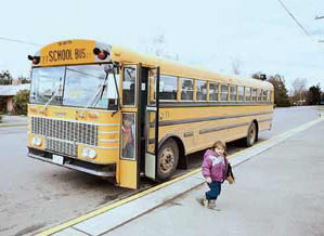 Children get off of a school bus.